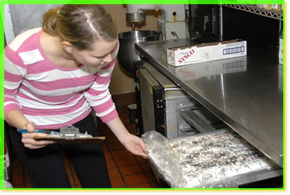 The Certified Food Manager inspecting food.