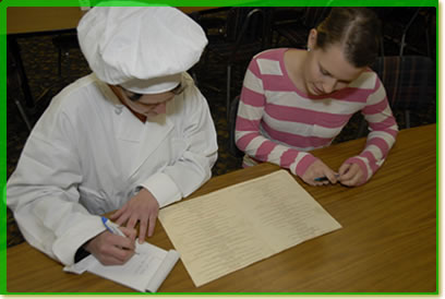 Certified Food Manager and chef reviewing menu.