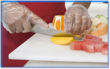 Kitchen worker cutting fruit.