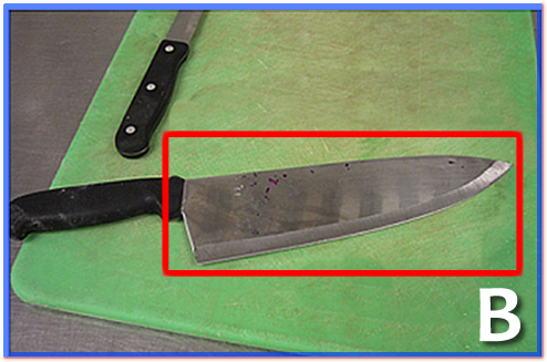 A dirty knife on a cutting board.