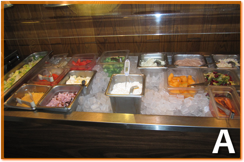 A container of cottage cheese on top of the ice in a salad bar,