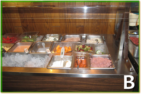 A container of cottage cheese in a salad bar,