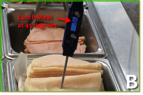 A digital thermometer in lunch meat showing 45 degrees.